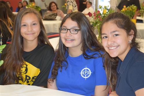 Three gifted female students smiling.