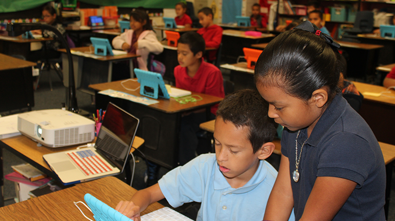 Students working on an iPad.
